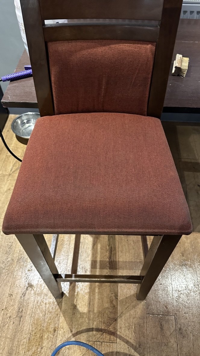 The same bar chair after cleaning by Jay's Cleaning. The seat back to its clean terracotta colour