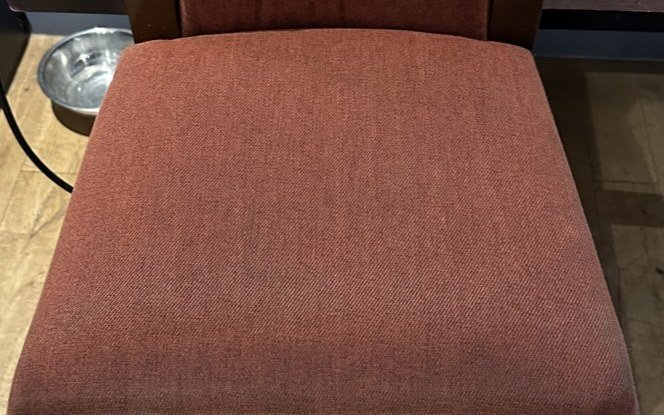 The same bar chair after cleaning by Jay's Cleaning. The seat back to its clean terracotta colour