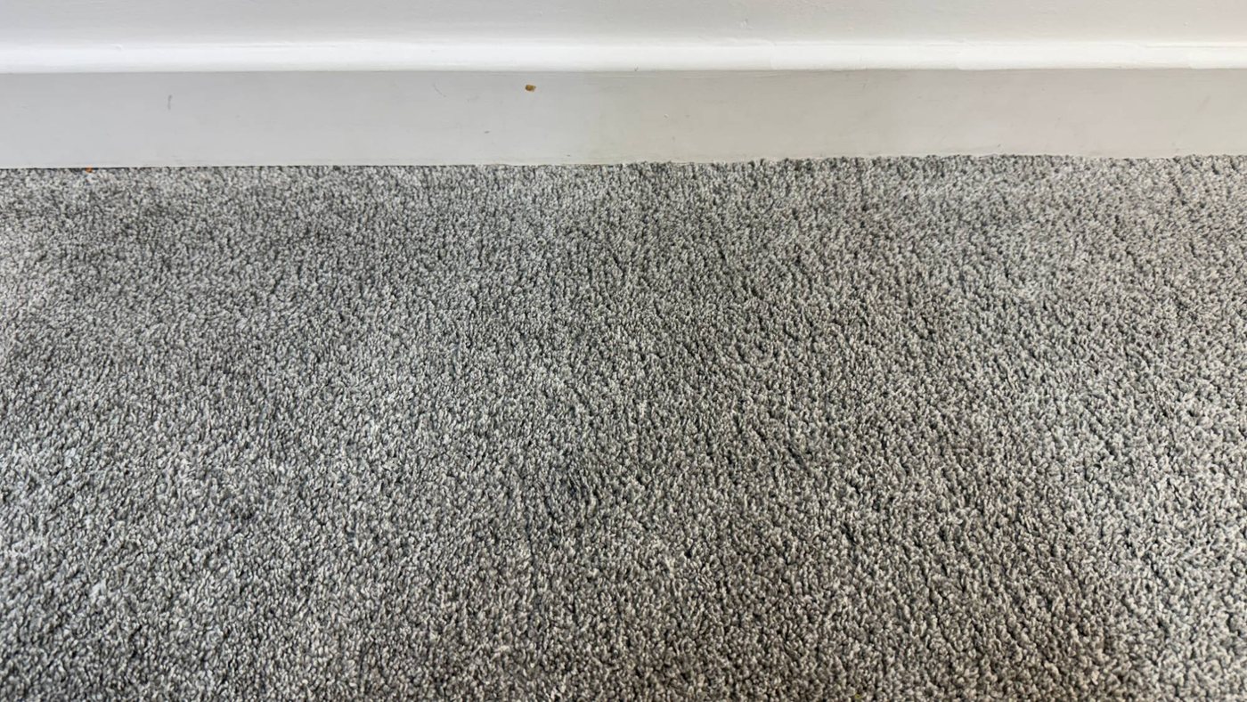 The same grey carpet with the chewing gum removed