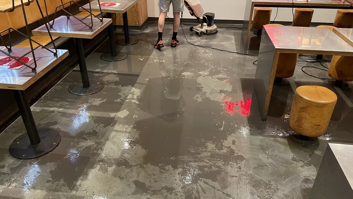 A dull, dirty restaurant hard floor before cleaning