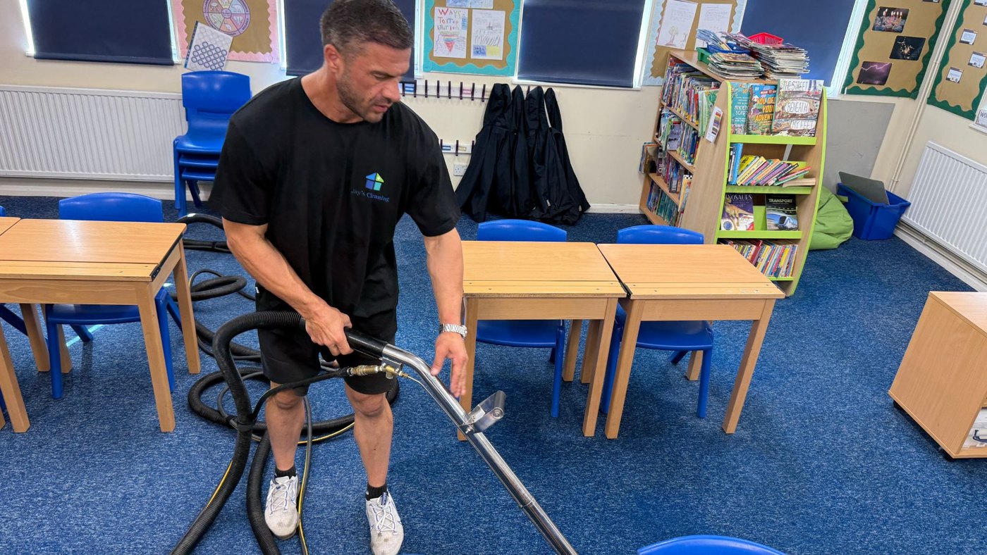 Jay deep-cleaning the carpet in a primary school classroom during the holidays