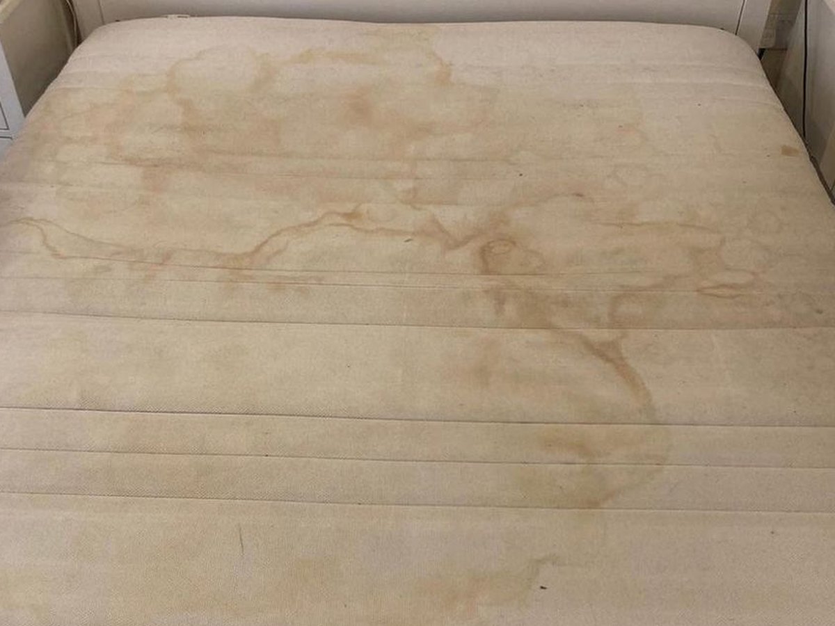 The same mattress before cleaning, stained and tired