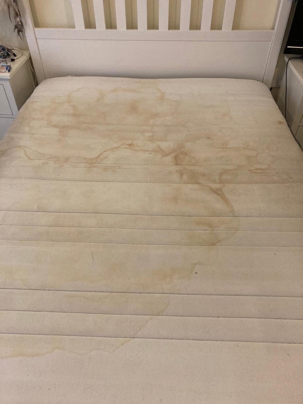 The same mattress before cleaning — stained and tired