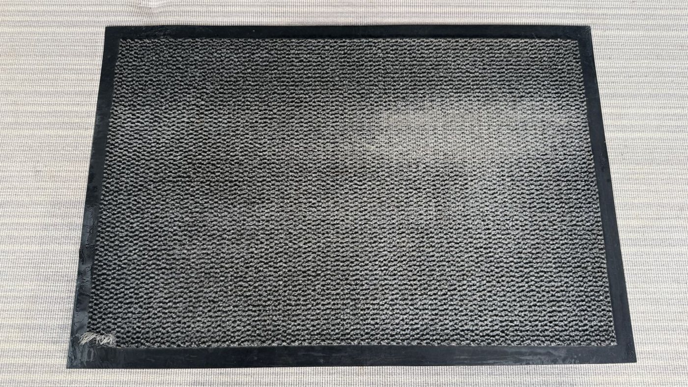 The same door mat cleaned back to grey