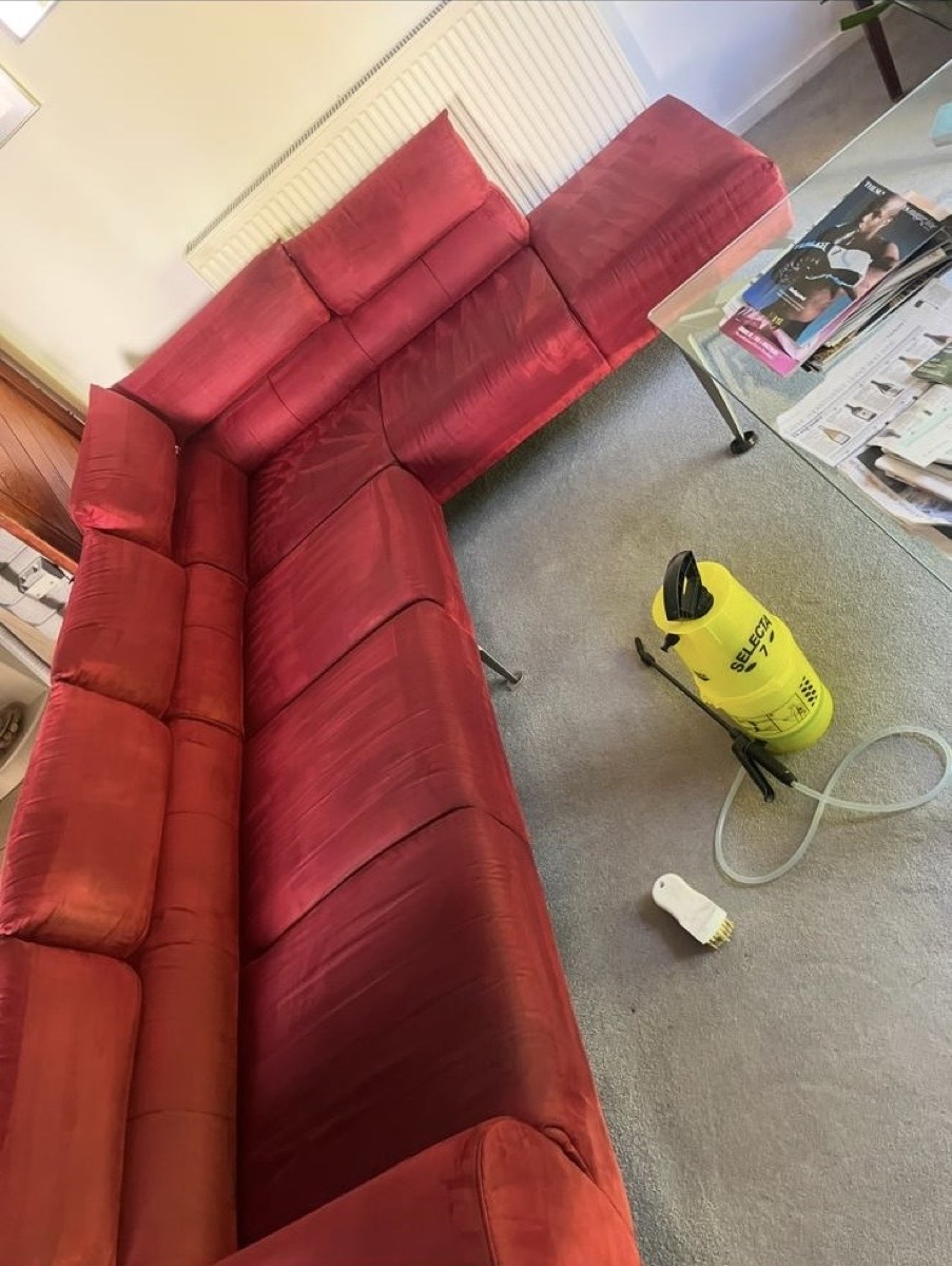The same red sofa after cleaning, colour lifted and refreshed