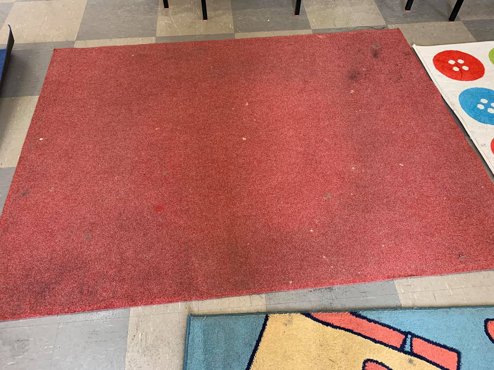 The same rug before cleaning — marked and dirty