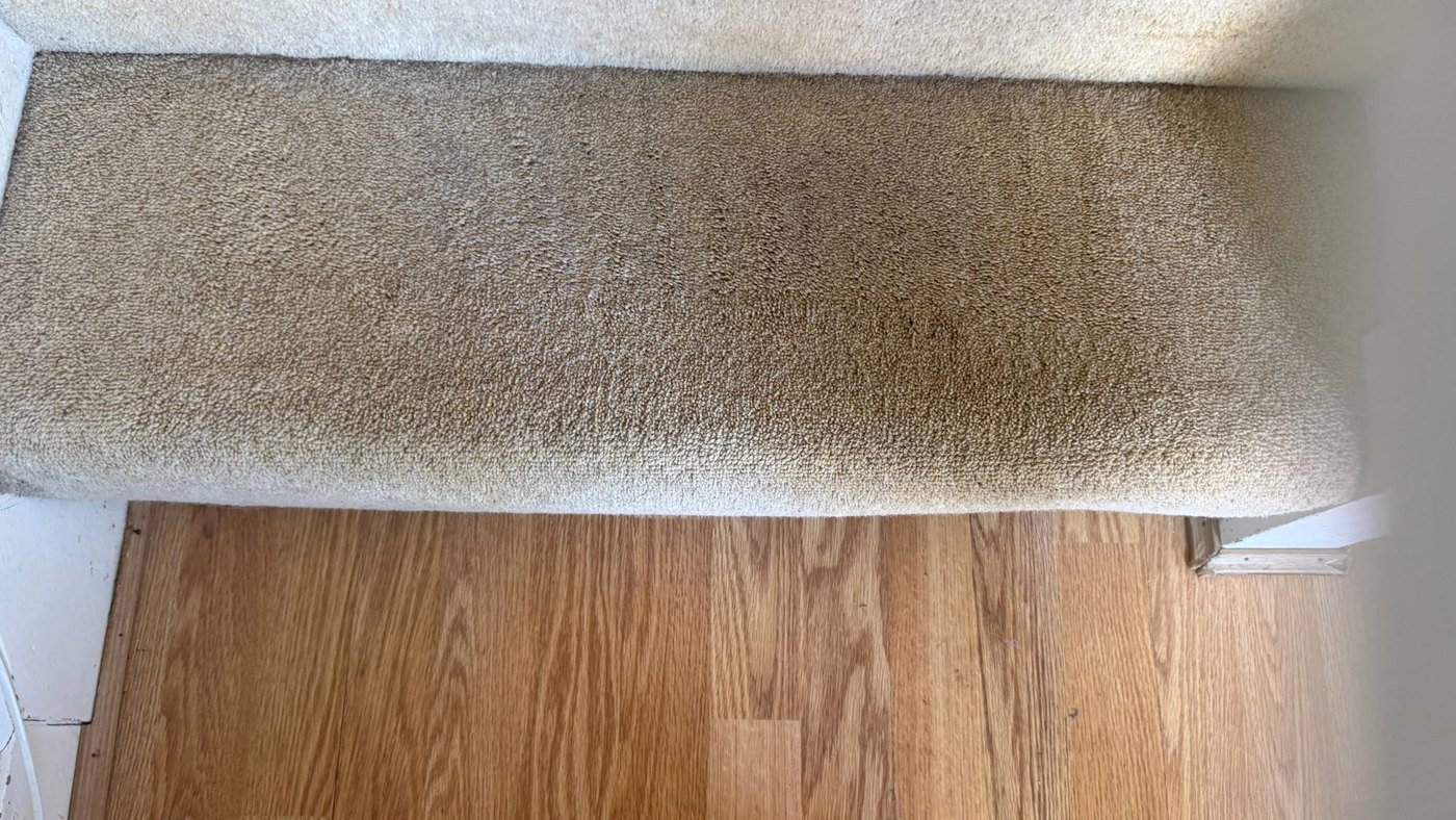 The same stair tread cleaned back to its original colour by Jay's Cleaning