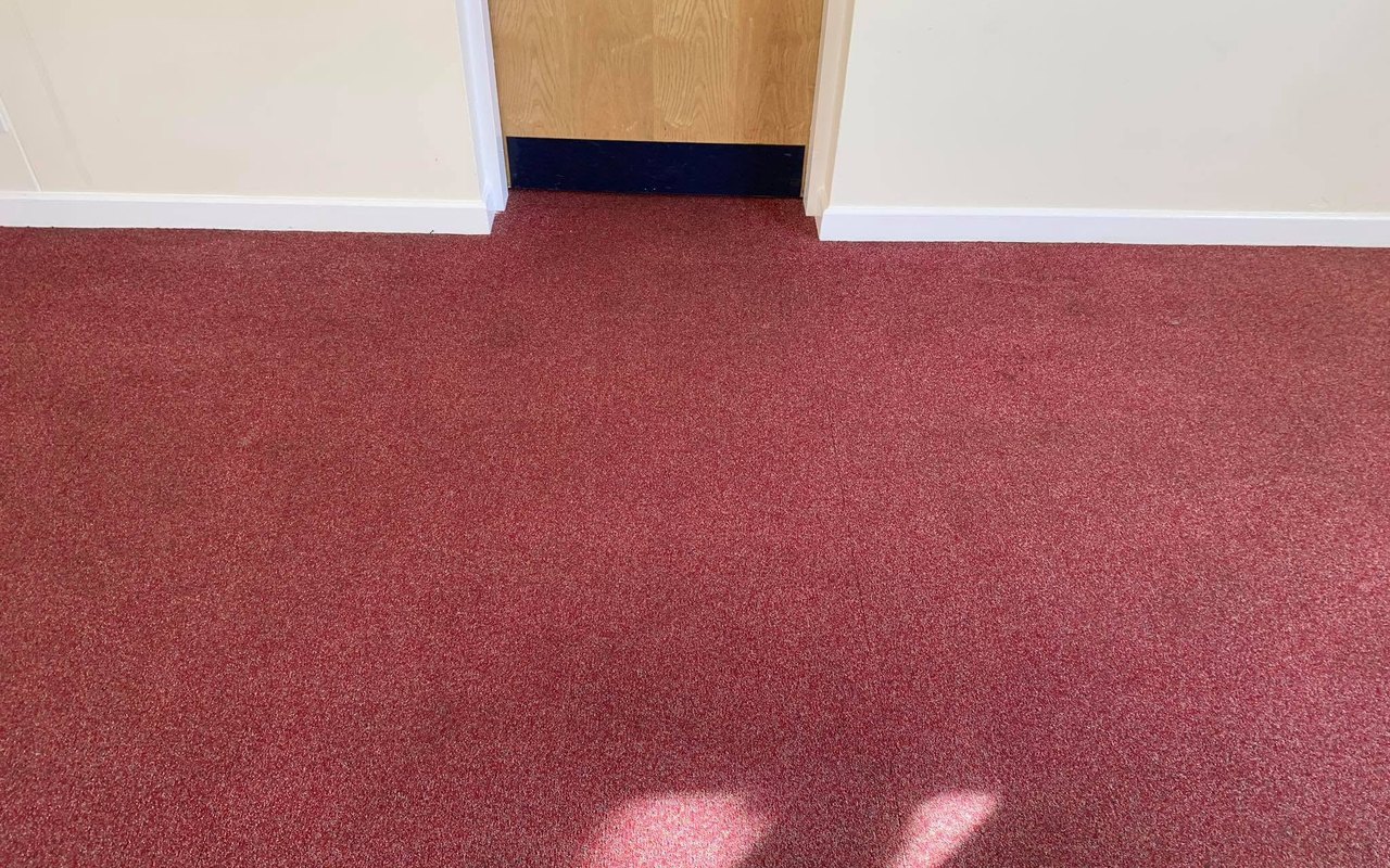 The same red carpet after the tea stain was removed