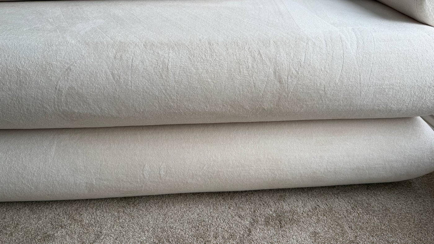 The same cream sofa cushion with the tea stain removed