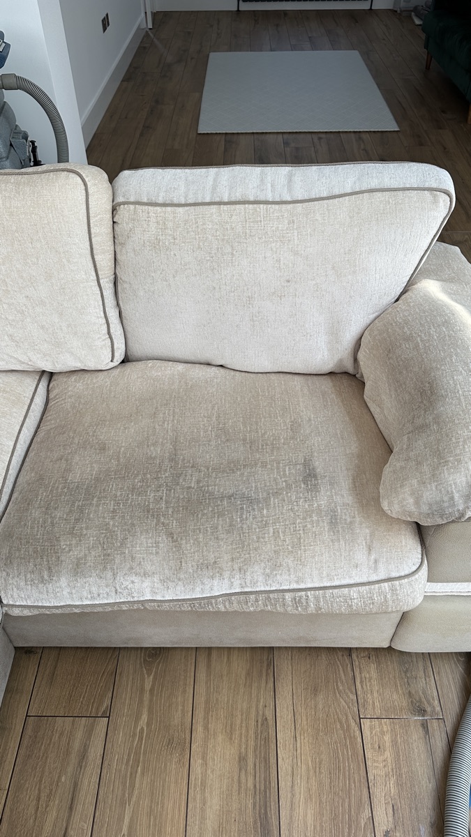 The same sofa before cleaning — soiled and worn