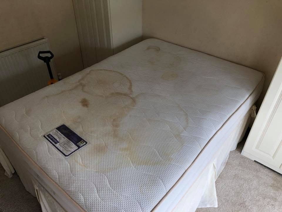 The same mattress before cleaning, heavy urine staining