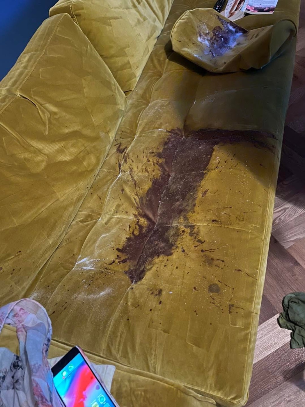 A red wine stain on a sofa before cleaning by Jay's Cleaning